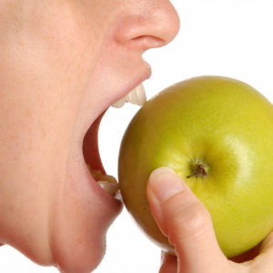 benefits of implants - eating an apple